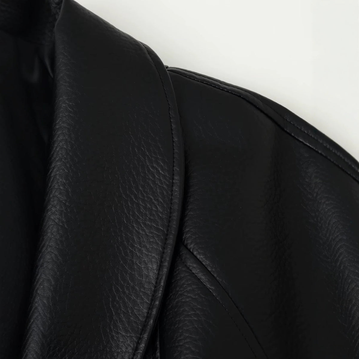 Wearing a PU leather jacket with a belt for women